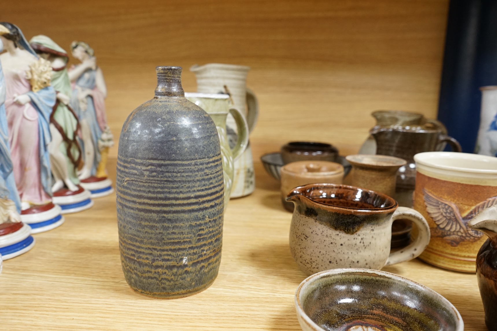 A large collection of studio pottery mugs bowls and jugs, tallest jug 21cm.